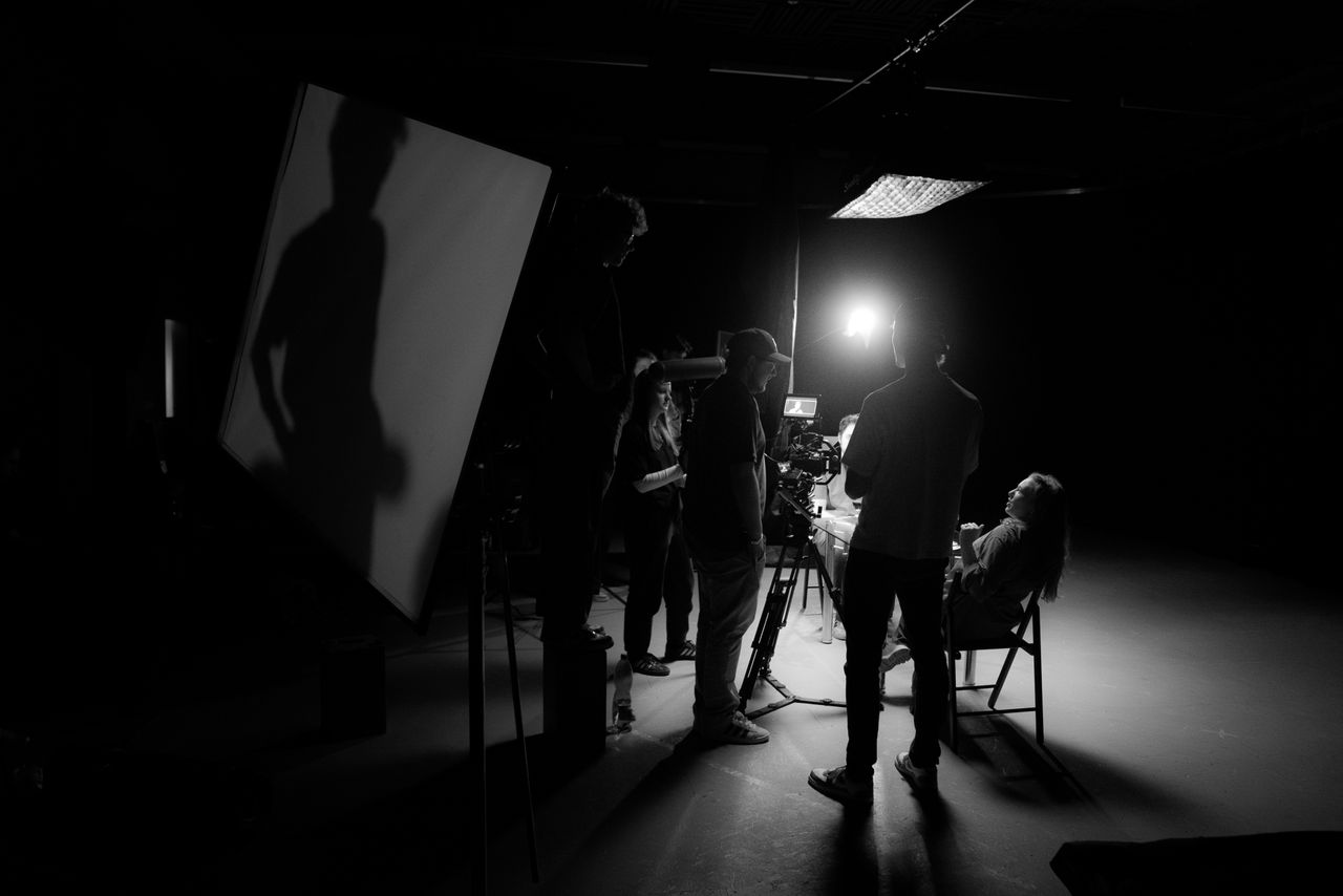 Mastering the First Impression: Your intriguing post title goes here A black and white view of a film crew working on set with dramatic lighting.